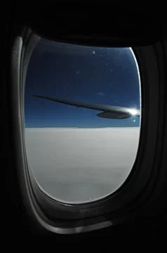 Sky and clouds Through Flight Window Stock Photos