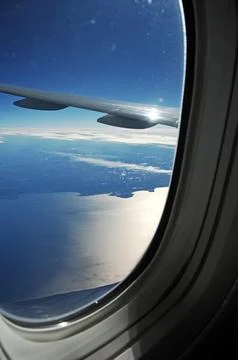 Sky and clouds Through Flight Window Stock Photos