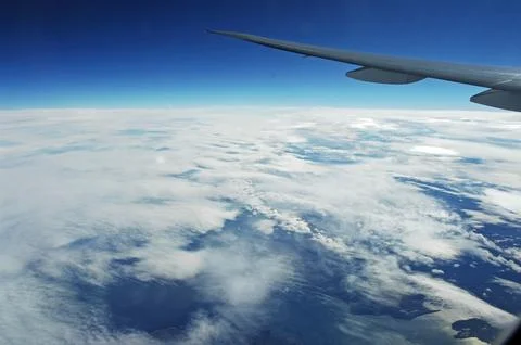Sky and clouds Through Flight Window Stock Photos