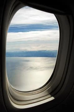 Sky and clouds Through Flight Window Stock Photos