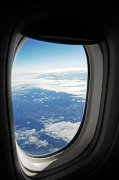 Sky and clouds Through Flight Window Stock Photos