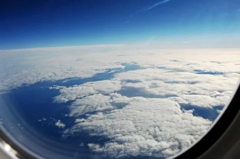 Sky and clouds Through Flight Window Stock Photos