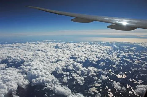 Sky and clouds Through Flight Window Stock Photos