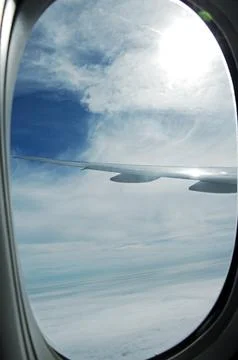 Sky and clouds Through Flight Window Stock Photos
