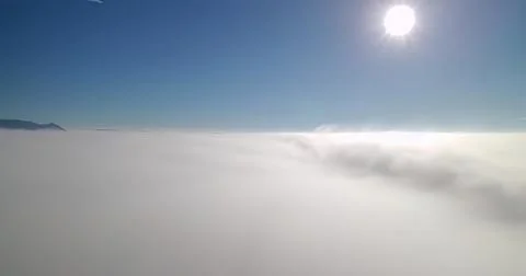Sky and clouds view from above with bright sun and blue sky Stock Photos