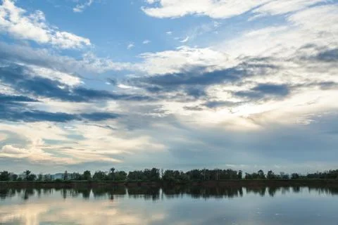The sky and the forest are reflected in the river. Stock Photos