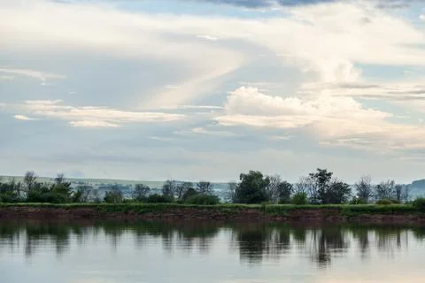 The sky and the forest are reflected in the river. Stock Photos