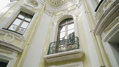 The sky and tree branches are reflected in the windows of the building Stock Footage 163900519