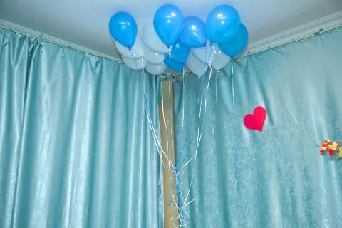 Sky and white balloons float on the white ceiling in the room for the party. Sky Stock Photos