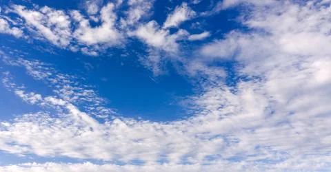 Sky background with blue clouds in texture. Bright sky with soft white clou.. Stock Photos