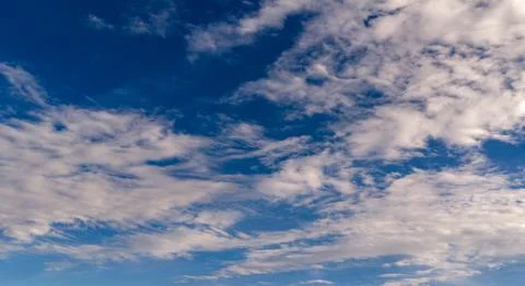 Sky background with cirrus clouds. Blue sky soft white texture. Bright sky wa Stock Photos