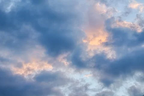 Sky background with sunlight through clouds at sunset Stock Photos