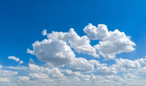 Sky background with sunny clouds. Blue sky frames white clouds. Summer sky .. Stock Photos