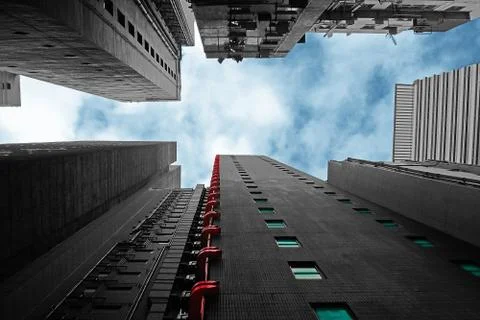 Sky between buildings. Low angle view from the ground on raising skyscrapers 스톡 사진