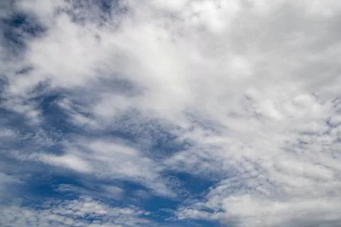 Sky is blue and cloudy. The clouds are white and fluffy Stock Photos