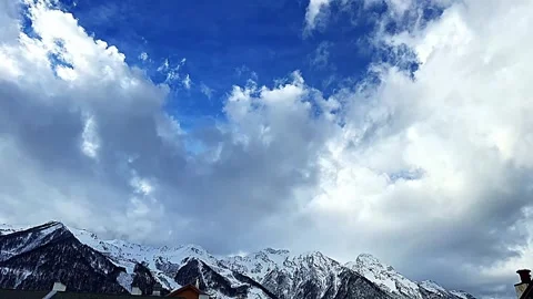 The sky is blue and cloudy with snow-capped mountains in the background Stock Footage 278146571