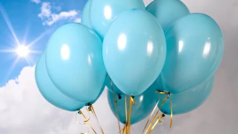 Sky Blue Balloons Floating Against a Sunny Sky Backdrop Stock Footage 333410598
