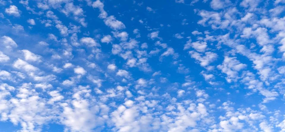 Sky blue clouds pattern. Bright sky cloud texture backdrop. Soft white sky wa Stock Photos
