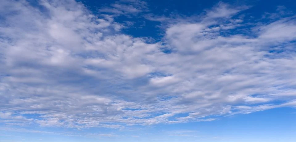 Sky blue clouds pattern. Bright sky cloud texture backdrop. Soft white sky wa 写真素材