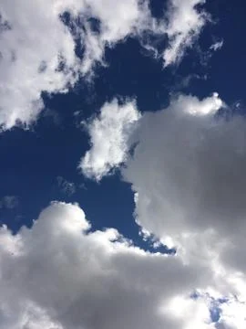 The sky is blue with a few clouds scattered throughout Stock Photos