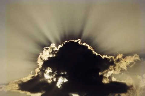 Sky Bright sun rays shining from grey cloud with silver lining tropical ra... Stock Photos