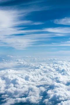 The sky is clear blue with fluffy white clouds Stock Photos