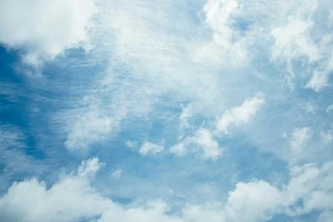 The sky is clear blue with fluffy white clouds Stock Photos