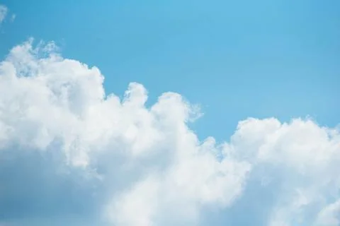 The sky is clear blue with fluffy white clouds Stock Photos