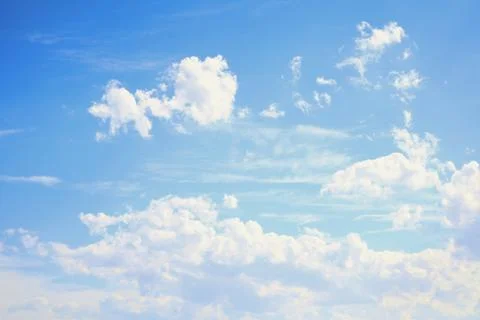 The sky is clear blue with fluffy white clouds Stock Photos