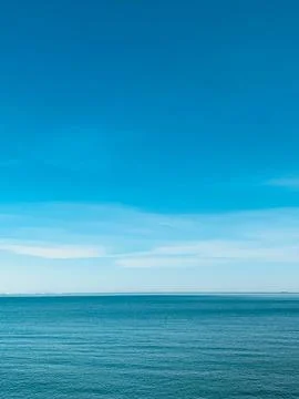 The sky is clear blue with fluffy white clouds Stock Photos