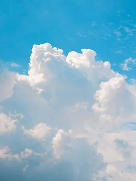 The sky is clear blue with fluffy white clouds Stock Photos