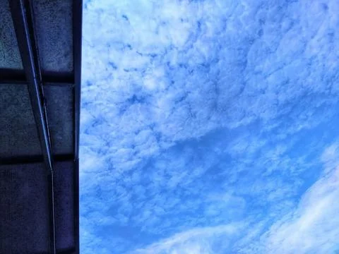 The sky is clear blue with fluffy white clouds Stock Photos