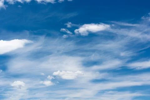 The sky is clear blue with fluffy white clouds Stock Photos