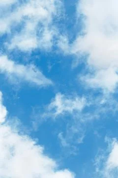 The sky is clear blue with fluffy white clouds Stock Photos