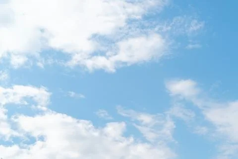 The sky is clear blue with fluffy white clouds Stock Photos