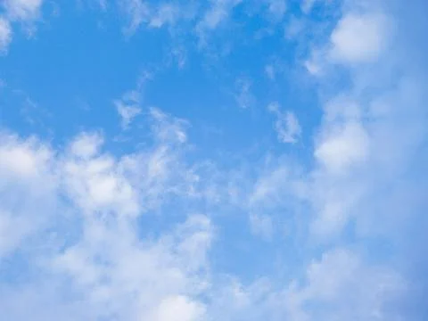 The sky is clear blue with fluffy white clouds Stock Photos