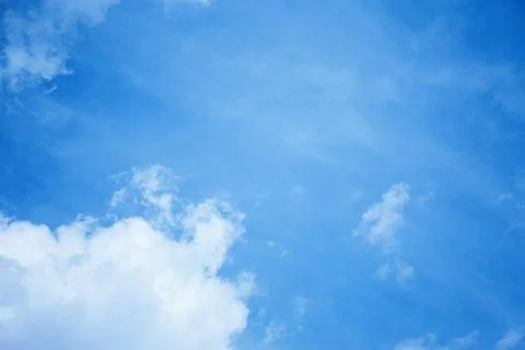 The sky is clear blue with fluffy white clouds Stock Photos