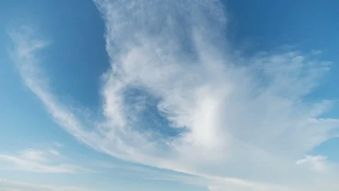 Sky on a clear day, with a white cloud moving slowly. Stock Footage 94651964