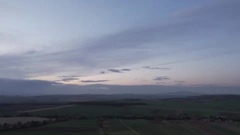 Sky with clouds after sunset, agricultural fields and mountains Stock Footage 259407012