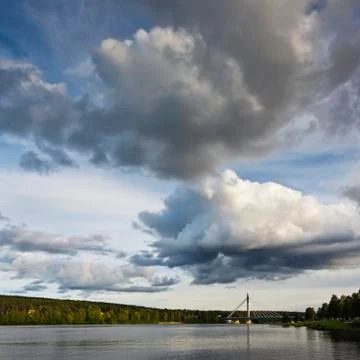 The sky with clouds and a bridge over the river. Finland Stock Photos