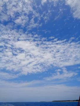 Sky with clouds and ocean horizon Stock Photos
