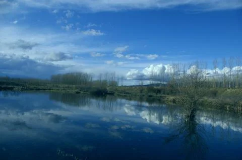 Sky with clouds are reflected in the water surface 스톡 사진
