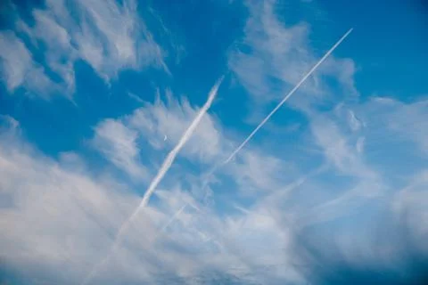 Sky with clouds moon and plane trails Stock Photos