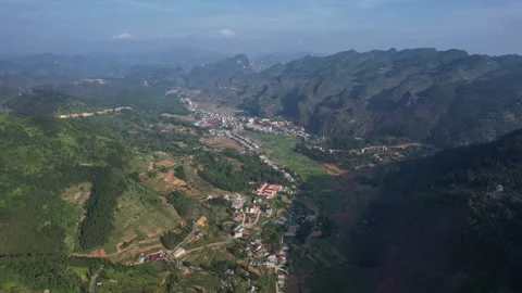 Sky, clouds, mountains, trees create natural landscape in valley Ha Giang Loop Stock Footage 277592643
