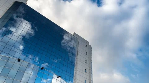 Sky with clouds reflected in a modern office glass building Stock Footage 42825348