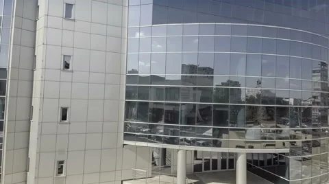Sky with clouds reflected in a modern office glass building Stock Footage 67896059