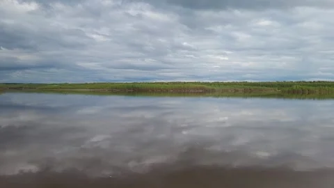 The sky with clouds is reflected in the river Video stock 195213945