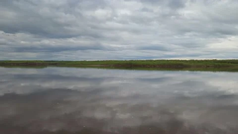 The sky with clouds is reflected in the river Video stock 195214649