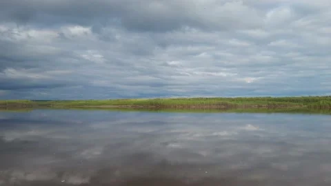 The sky with clouds is reflected in the river Stock Footage 195214735