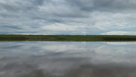 The sky with clouds is reflected in the river Stock Footage 195215582